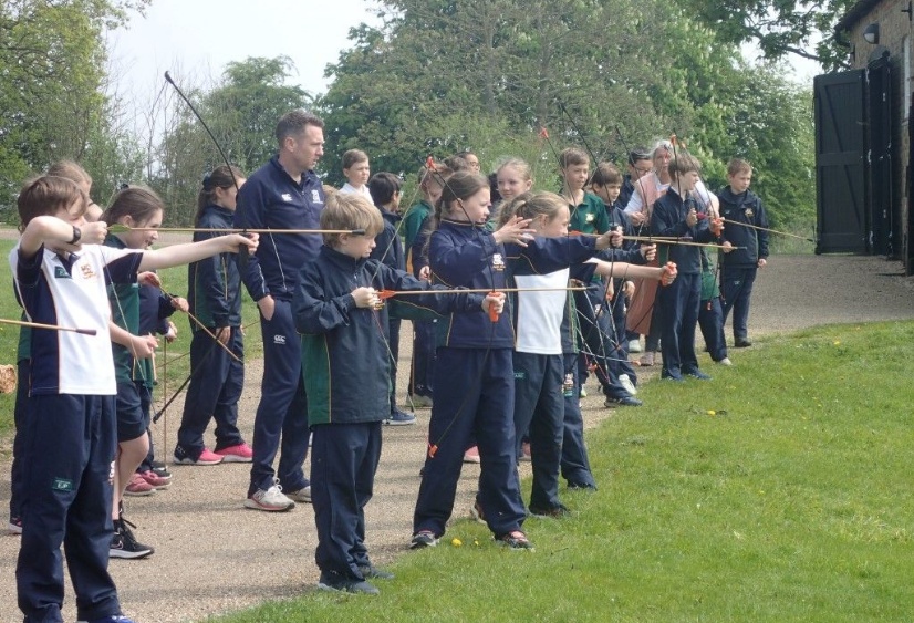 a group of Heath Mount children try their hand at archery at Cressing Temple Barns in Essex